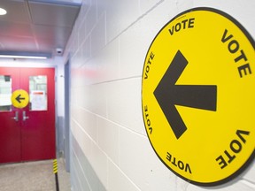 An arrow points to where people can go to cast their ballots on federal election day in Montreal, Sept. 20, 2021.