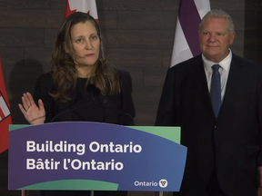 Federal Deputy Prime Minister Chrystia Freeland speaks in Ohsweken, Ont. as Ontario Premier Doug Ford listens on Friday, Feb. 10, 2023.