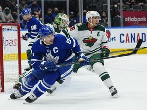 Toronto Maple Leafs forward John Tavares  and Minnesota Wild defenseman Jared Spurgeon battle for position during the third period at Scotiabank Arena.