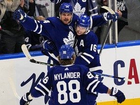 Toronto Maple Leafs forward Mitchell Marner and forward William Nylander congratulate forward Auston Matthews on his goal against the Tampa Bay Lightning during the second period of game one of the first round of the 2022 Stanley Cup Playoffs at Scotiabank Arena.
