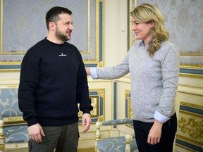 This handout photograph taken and released by the Ukrainian Presidential Press Service on Feb. 14, 2023, shows Ukrainian President Volodymyr Zelensky welcoming Canada's Foreign Minister Melanie Joly prior to their meeting in Kyiv.