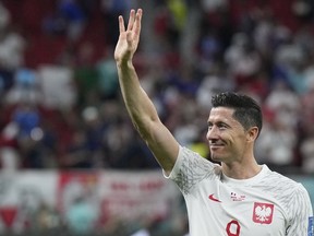 Poland's Robert Lewandowski waves after the World Cup round of 16 soccer match between France and Poland, at the Al Thumama Stadium in Doha, Qatar, on Dec. 4, 2022.