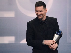 Argentina and Paris Saint-Germain forward Lionel Messi poses on stage after receiving the Best FIFA Mens Player award during the Best FIFA Football Awards 2022 ceremony in Paris on Feb. 27, 2023.