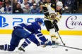 Boston Bruins' Brad Marchand passes past Maple Leafs' Morgan Rielly during the third period in Toronto on Wednesday, Feb. 1, 2023.