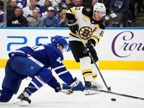 Boston Bruins' Brad Marchand passes past Maple Leafs' Morgan Rielly during the third period in Toronto on Wednesday, Feb. 1, 2023.