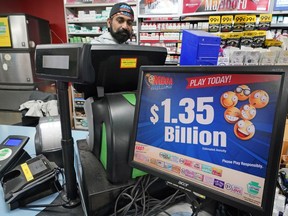 A Mega Million sign displays the estimated jackpot of $1.35 billion at the Cranberry Super Mini Mart in Cranberry, Pa., Jan. 12, 2023.