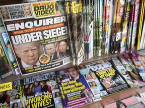 In this July 12, 2017 file photo, an issue of the National Enquirer featuring U.S. President Donald Trump on its cover is displayed on a newsstand in a store in New York City.