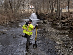Ron Fodo, Ohio EPA Emergency Response, looks for signs of fish and also agitates the water in Leslie Run creek to check for chemicals that have settled at the bottom following a train derailment that is causing environmental concerns on Feb. 20, 2023 in East Palestine, Ohio.