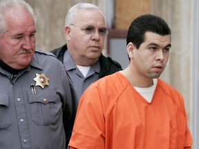 Anthony Sanchez, right, is escorted into a Cleveland County courtroom for a preliminary hearing in Norman, Okla., on Feb. 23, 2005. The Oklahoma death row inmate convicted of raping and killing a University of Oklahoma dance student is seeking to have his death sentence thrown out.