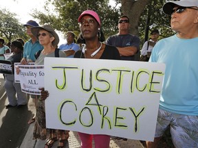 Attendees hold signs in support of Corey Jones at a "Rally for Answers," Oct. 22, 2015, in Palm Beach Gardens, Fla.