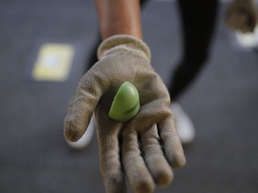 A protester holds up a fragmented piece of a Sponge round used to cause blunt trauma after a protest in Hong Kong, Sept. 22, 2019.