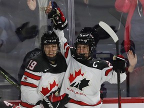 Marie-Philip Poulin (right) celebrates her goal with teammate Brianne Jenner during the final game of the Rivalry Series in Laval on Wednesday February 22, 2023.