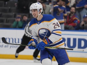 Buffalo Sabres' Dylan Cozens (24) smiles after scoring an empty-net goal during the third period of an NHL hockey game against the St. Louis Blues Tuesday, Jan. 24, 2023, in St. Louis.