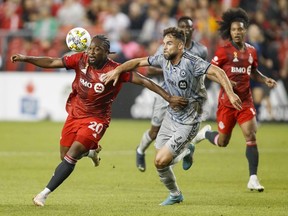 Toronto FC forward Ayo Akinola and CF Montreal defender Rudy Camacho battle of the ball during first half MLS soccer action in Toronto on Sunday, Sept. 4, 2022.