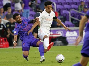 Orlando City midfielder Jake Mulraney, left, fight for position on the ball against FC Dallas midfielder Brandon Servania, right, during the first half of an MLS soccer match, in Orlando, Fla., Saturday, May 28, 2022.&ampnbsp;Toronto FC has acquired midfielder Brandon Servania from FC Dallas in exchange for Spanish striker Jesus Jimenez and an international slot for the 2023.