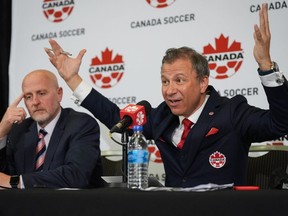 Canada Soccer president Nick Bontis, right, speaks as interim general secretary Earl Cochrane listens during a news conference, in Vancouver, on Sunday, June 5, 2022.