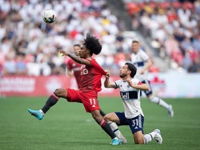 Toronto FC's Jayden Nelson and Vancouver Whitecaps' Russell Teibert vie for the ball during the first half of the Canadian Championship soccer final, in Vancouver, on Tuesday, July 26, 2022.