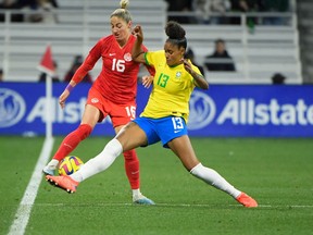 Canada forward Janine Beckie (16) and  Brazil defender Tarciane (13) fight for the ball during the first half at Geodis Park on Feb. 19, 2023.