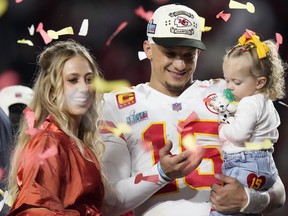 Kansas City Chiefs quarterback Patrick Mahomes (15) and his wife Brittany, left, celebrate with their daughter, Sterling Skye Mahomes, after the NFL Super Bowl 57 football game, Sunday, Feb. 12, 2023, in Glendale, Ariz. The Kansas City Chiefs defeated the Philadelphia Eagles 38-35.