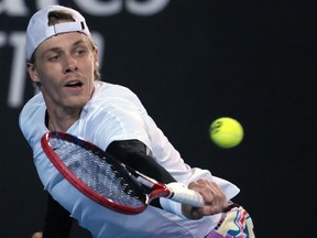 Denis Shapovalov of Canada plays a backhand return to Taro Daniel of Japan during their second round match at the Australian Open tennis championship in Melbourne, Australia, Wednesday, Jan. 18, 2023.