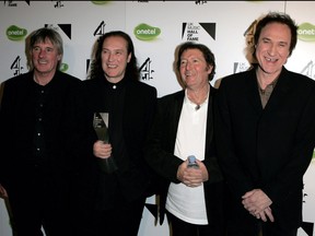 The Kinks band members (from left to right) Mick Avory, Dave Davies, Peter Quaife and Ray Davies pose backstage with the award for their induction into the U.K. Music Hall of Fame at Alexandra Palace on Nov. 16, 2005 in London.