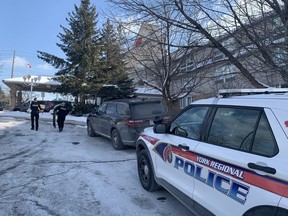 Two York Regional Police officers are pictured at the Monte Carlo Inn in Markham on Feb. 1, 2023, after a baby boy was critically injured. A 61-year-old man, who was a family member, has been charged with attempted murder.