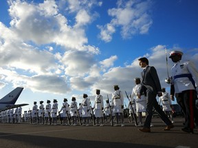 Prime Minister Justin Trudeau inspects an honour guard as he arrives in Nassau, Bahamas, Wednesday, Feb. 15, 2023.