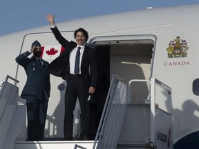 Prime Minister Justin Trudeau waves as he boards a government plane at the airport in Ottawa, Thursday, June 10, 2021.