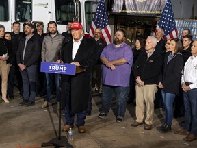 Former president Donald Trump stands next to a pallet of water before delivering remarks at the East Palestine Fire Department station on Feb. 22, 2023 in East Palestine, Ohio.