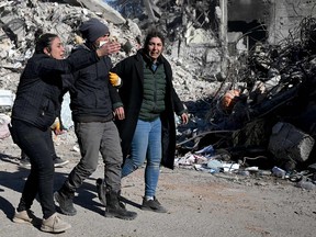 Relatives react after identifying a body as a family member in Kahramanmaras, southern Turkey on February 13, 2023.