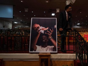 A poster of Tyre Nichols holding his daughter is displayed during a news conference at Mason Temple: Church of God in Christ World Headquarters in Memphis, Tennessee, on Jan. 31, 2023.