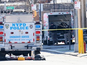 NYPD officers search a crashed U-Haul truck on Hamilton Avenue on February 13, 2023 in Brooklyn.