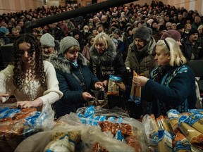 Church members distribute food to local residents after a mass at the Ark of Salvation Church in Kramatorsk on Feb. 12, 2023, amid the Russian invasion of Ukraine.