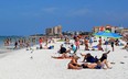 People gather on Clearwater Beach during spring break in Clearwater, Florida on March 18, 2020.