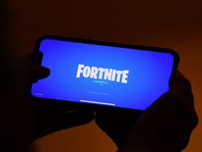 A person logs into Epic Games' Fortnite on their smartphone.