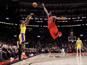Lonnie Walker IV of the Los Angeles Lakers puts a shot up over Pascal Siakam of the Toronto Raptors during the second half of their NBA game at Scotiabank Arena on December 7, 2022 in Toronto, Canada.