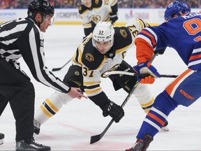 Patrice Bergeron of the Boston Bruins sets for a face off in the first period against the Edmonton OilersM on February 27, 2023 at Rogers Place in Edmonton, Alberta, Canada.