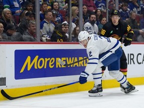 Luke Schenn of the Toronto Maple Leafs defends against Andrei Kuzmenko #96 of the Vancouver Canucks during the first period of their NHL game at Rogers Arena on March 4, 2023 in Vancouver, British Columbia, Canada.