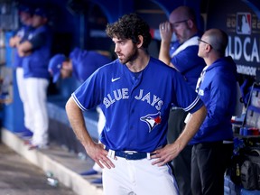 Jordan Romano of the Toronto Blue Jays looks on from the dugout after losing 10-9 to the Seattle Mariners in Game 2 of the American League wild card series at the Rogers Centre on October 08, 2022.