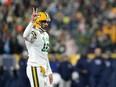 Aaron Rodgers of the Green Bay Packers calls for a two point conversion after a touchdown against the Tennessee Titans during the third quarter in the game at Lambeau Field on November 17, 2022 in Green Bay, Wisconsin.