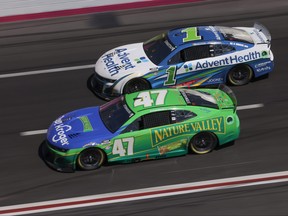 Ricky Stenhouse Jr., driver of the #47 Kroger/Nature Valley Chevrolet, and Ross Chastain, driver of the #1 Advent Health Chevrolet, race during the NASCAR Cup Series Ambetter Health 400 at Atlanta Motor Speedway on March 19, 2023 in Hampton, Georgia.