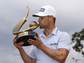 Taylor Moore of the United States celebrates with the trophy after winning during the final round of the Valspar Championship at Innisbrook Resort and Golf Club on March 19, 2023 in Palm Harbor, Fla.