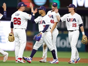 Mookie Betts of Team USA and Aaron Loup celebrate after defeating Team Cuba 14-2 during the World Baseball Classic Semifinals at loanDepot park on March 19, 2023 in Miami, Fla.