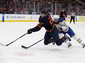 The Edmonton Oilers' Connor McDavid battles the Buffalo Sabres' Kyle Okposo  during third period NHL action at Rogers Place in Edmonton, Tuesday Oct. 18, 2022.