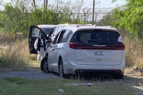 A Mexican police investigator inspects the minivan were four Americans where shot and taken from last week, at the Tamaulipas State Prosecutor´s headquarters in Matamoros, Mexico, Wednesday, March 8, 2023.