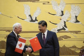 Canada’s Governor General David Johnston (L) shakes hands with Chinese President Xi Jinping (R) after a signing ceremony at the Great Hall of the People in Beijing on October 18, 2013. Johnston’s visit is aimed at boosting relations between Canada and China. ENDO/AFP/Getty Images