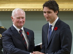 Canadian Prime Minister Justin Trudeau (R) shakes hands with Governor General David Johnston after being sworn in as prime minister at Rideau Hall in Ottawa on November 4, 2015.