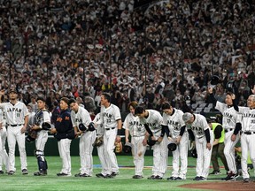 Members of Japan's team bow to thank the crowd at the end of their 9-3 victory in the World Baseball Classic (WBC) quarter-final game between Japan and Italy at the Tokyo Dome in Tokyo on March 16, 2023.