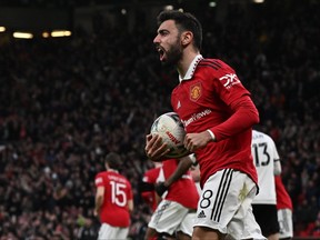 Manchester United's Portuguese midfielder Bruno Fernandes celebrates after scoring their first goal from the penalty spot during the English FA Cup quarter-final football match between Manchester United and Fulham at Old Trafford in Manchester, north-west England, on March 19, 2023.