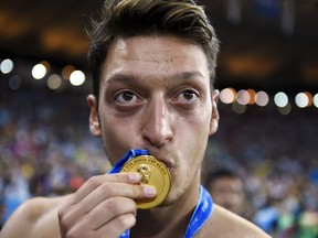 (FILES) In this file photo taken on July 13, 2014 Germany's midfielder Mesut Ozil kisses his medal after Germany won the 2014 FIFA World Cup final football match between Germany and Argentina 1-0 following extra-time at the Maracana Stadium in Rio de Janeiro, Brazil. - World Cup winner Mesut Ozil announced his retirement from football on March 22, 2023 after an illustrious international career with Germany and club spells with Real Madrid and Arsenal.